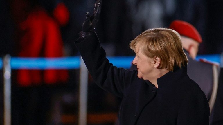 A chanceler da Alemanha, Angela Merkel, acena para o público no Ministério da Defesa durante a cerimônia militar Grosser Zapfenstreich, em Berlim, em 2 de dezembro de 2021 - POOL/AFP